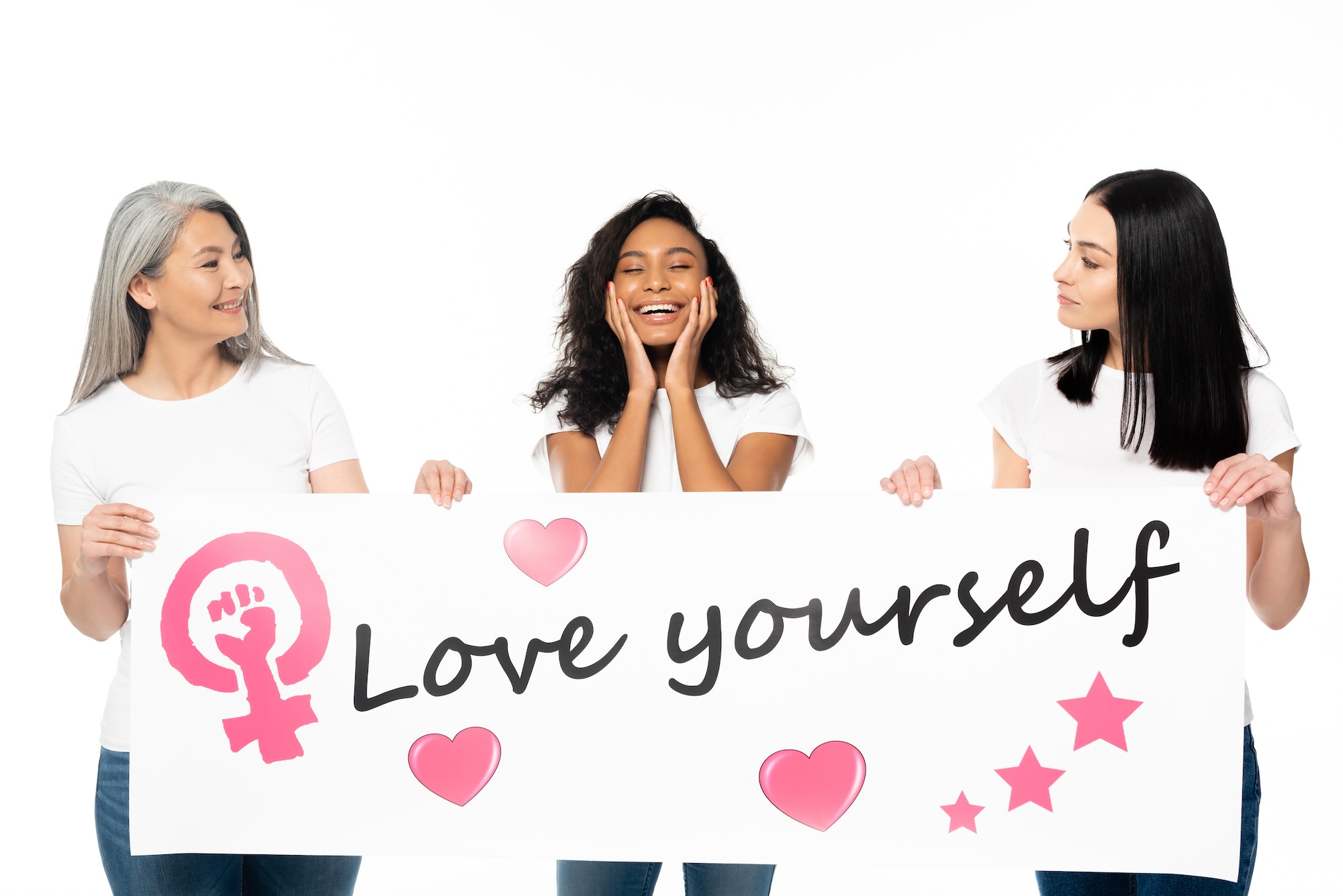 multicultural women holding placard with love yourself lettering isolated on white
