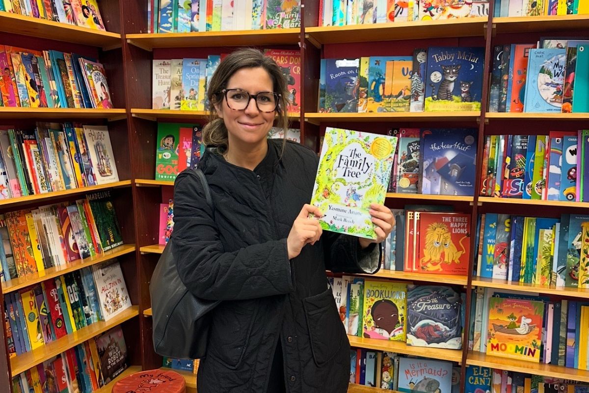 Yasmine Anane holding her book, The Family Tree
